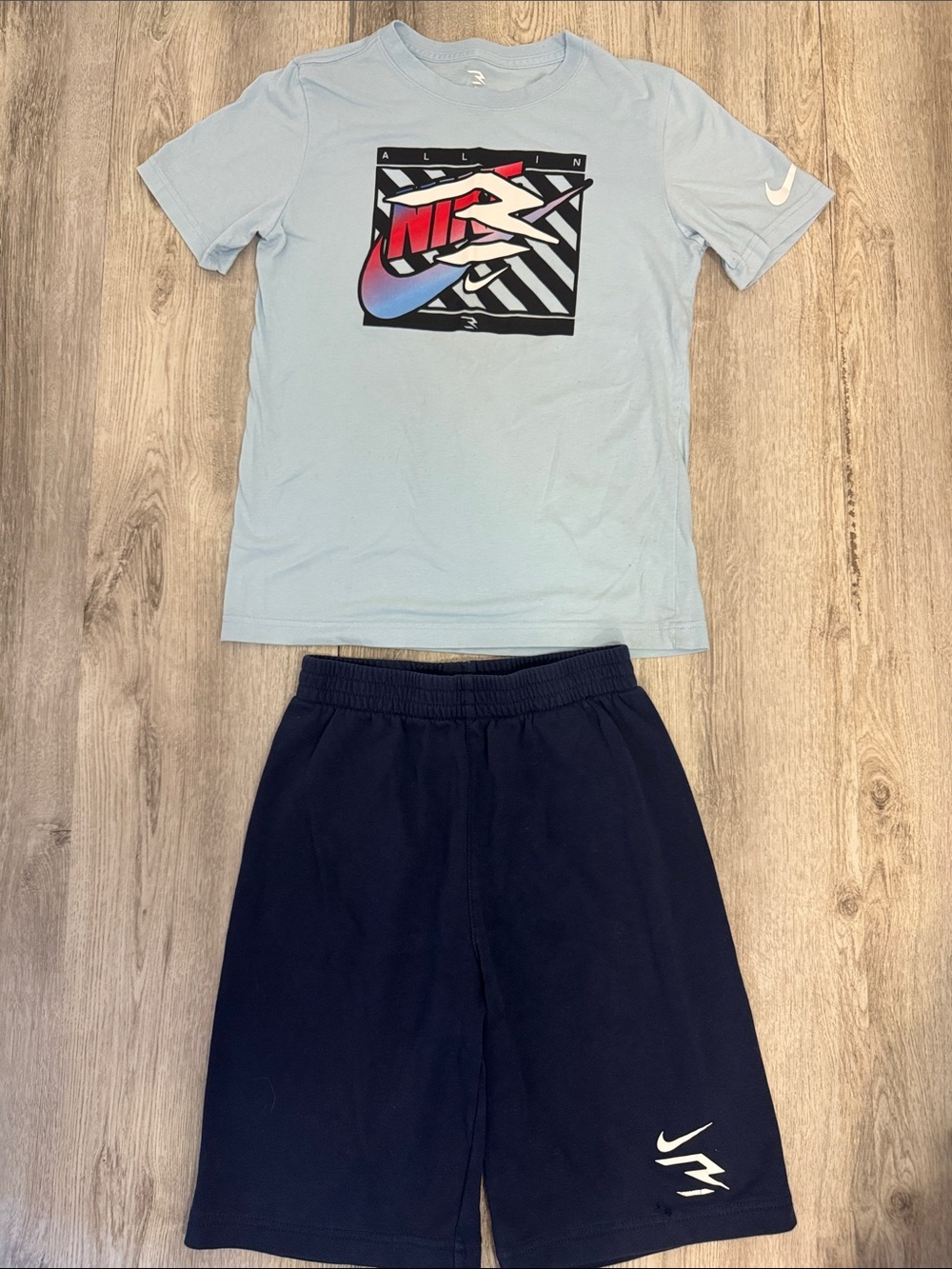Nike Light Blue Graphic Tee with Navy Shorts